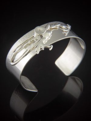 High-polish sterling silver cuff bracelet featuring a large, intricate hand-cast "molten" silver accent across the top.
