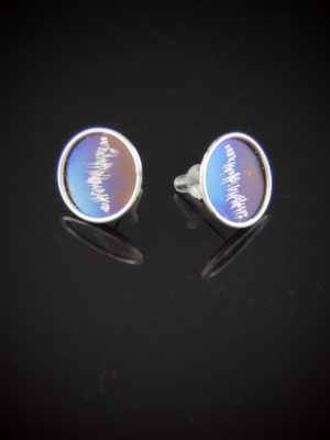 Round 1/2-inch stud earrings featuring iridescent blue anodized titanium disks with etched silver waveform patterns, encased in polished sterling silver rims