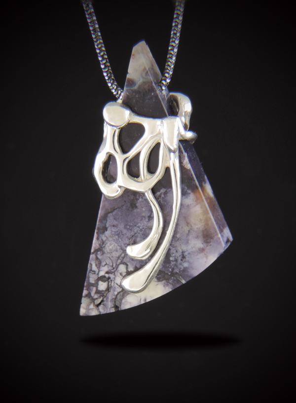 A geometric, triangular Purple Tiffany Stone pendant featuring intricate violet and white marbling, enveloped in an organic, molten-style sterling silver design. The pendant hangs from a dark gunmetal chain against a solid black background.