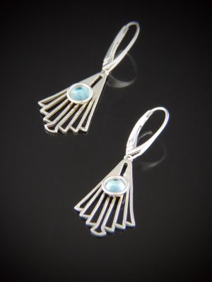 A pair of Bellini sterling silver earrings featuring fan-shaped geometric dangles with a round, light blue Swiss Blue Topaz cabochon set at the center, hanging from silver lever back hooks.