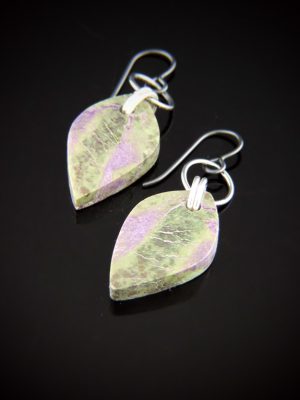 Leaf-shaped Atlantisite drop earrings with muted purple and green tones, suspended from Black Niobium shepherd's hook wires with diamond-cut Sterling Silver links