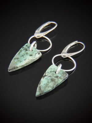 Arrowhead-shaped African Turquoise drop earrings with mottled teal and dark matrix patterning, suspended from Sterling Silver jump rings with lever back closures