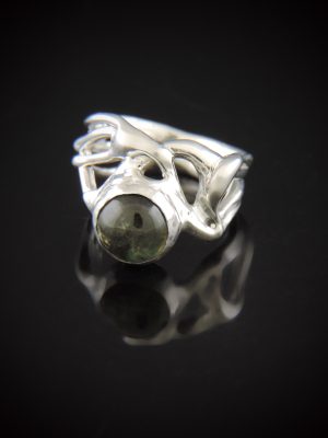 One-of-a-kind organic sterling silver Mojito ring featuring a round 9mm green tourmaline cabochon gemstone with natural inclusions, resting on a glossy black reflective surface.