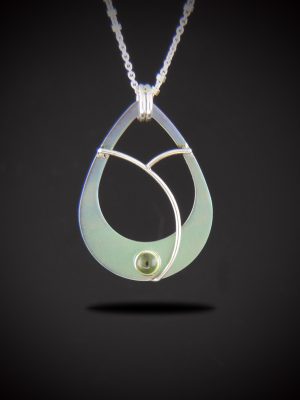 Alt Text: A teardrop-shaped titanium pendant necklace with an open center, showing a soft gradient color from lavender at the top to mint green at the bottom. A small, round green peridot gemstone is set at the bottom base, framed by elegant, curved sterling silver wire accents. The pendant hangs from a sterling silver chain against a dark gradient background.