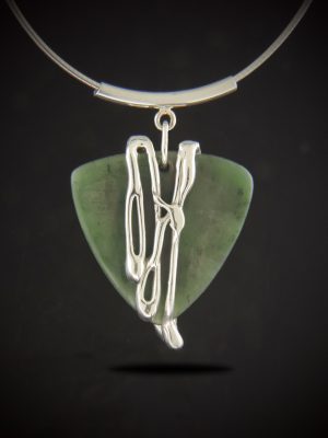 One-of-a-kind Jade Cocktail Necklace featuring a triangular guitar-pick shaped green Canadian nephrite jade with fluid sterling silver cascading down the front, hanging from a curved sterling tube bail and omega chain.